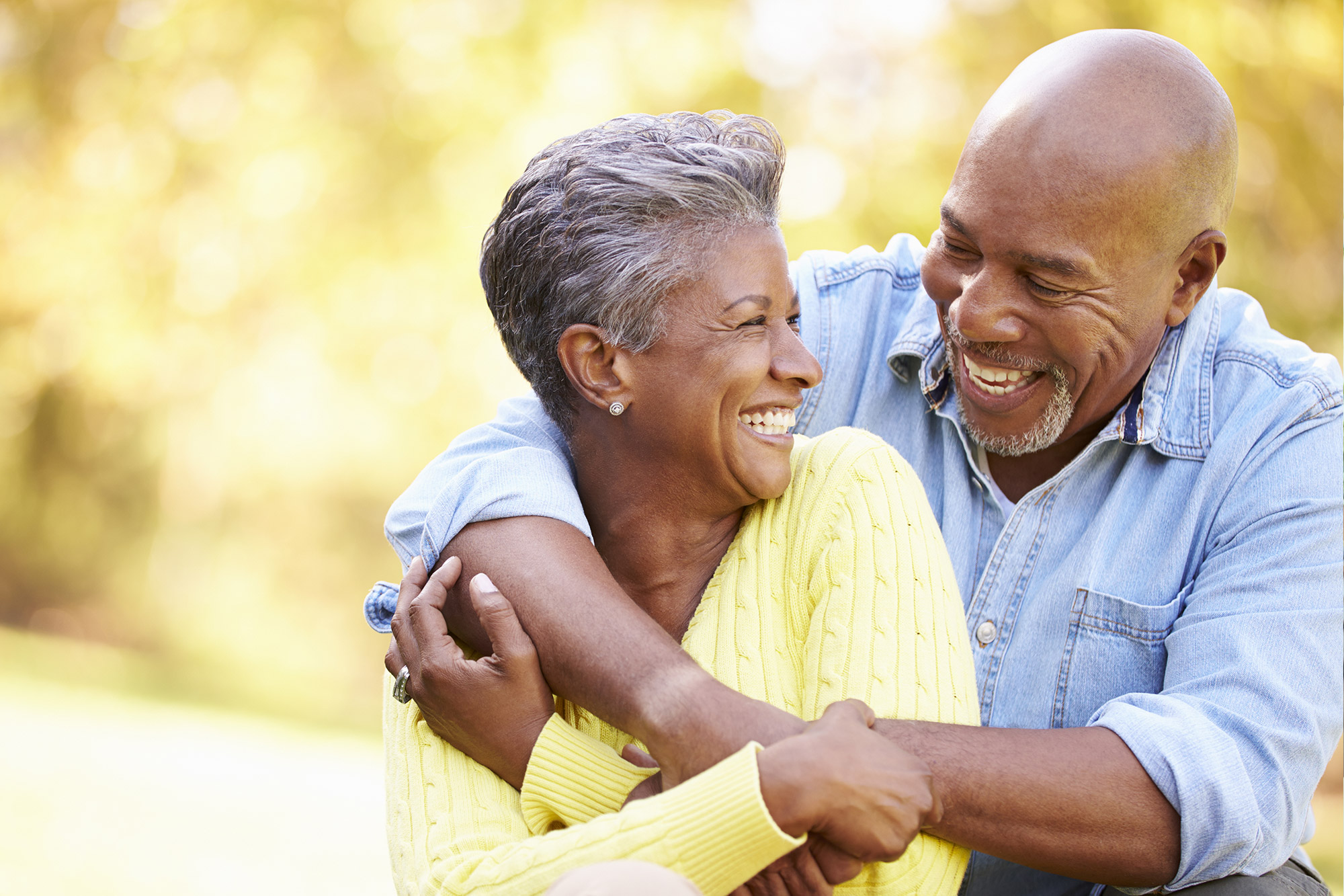 Retired couple hugging and smiling at each other